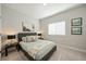 Neutral bedroom features a gray upholstered headboard with matching lamps and light, patterned bedding at 790 36Th N Ave, St Petersburg, FL 33704