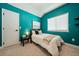 Cozy bedroom with blue walls, a comfortable bed, a window, and ample natural light at 790 36Th N Ave, St Petersburg, FL 33704