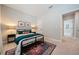 Bright bedroom with carpeted floors and a dark metal frame bed dressed with teal bedding at 790 36Th N Ave, St Petersburg, FL 33704