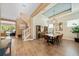 Bright dining room featuring modern light fixture, wood table, and bar cabinets with an adjacent view of the staircase at 790 36Th N Ave, St Petersburg, FL 33704