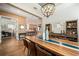Open concept dining room leading to the kitchen, with hardwood floors and a statement dining table at 790 36Th N Ave, St Petersburg, FL 33704