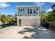Two-story house with a pool, white garage door, light blue siding, and lush landscaping at 790 36Th N Ave, St Petersburg, FL 33704