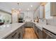 Modern kitchen features gray cabinets, stainless steel appliances, large island, and white subway tile backsplash at 790 36Th N Ave, St Petersburg, FL 33704