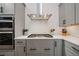 Modern kitchen features gray cabinets, stainless steel appliances, and white backsplash at 790 36Th N Ave, St Petersburg, FL 33704