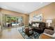 Cozy living room featuring a dark leather sofa and views of the backyard pool area through sliding glass doors at 790 36Th N Ave, St Petersburg, FL 33704