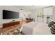 Bright living room featuring a murphy bed, breakfast table, TV, light-colored walls, and hardwood floors at 790 36Th N Ave, St Petersburg, FL 33704