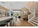 Open-concept living room with wood floors, with adjacent kitchen, and staircase leading to the second floor at 790 36Th N Ave, St Petersburg, FL 33704