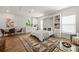 Bright living room with a murphy bed, breakfast table, light-colored walls, and hardwood floors with area rug at 790 36Th N Ave, St Petersburg, FL 33704