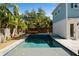 Backyard pool with spa and hammock, surrounded by tropical landscaping and a privacy fence at 790 36Th N Ave, St Petersburg, FL 33704