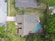 Aerial view of a home featuring a screened pool and a well-maintained roof at 854 Village Way, Palm Harbor, FL 34683