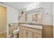 Bright bathroom features a granite vanity and shower with a floral curtain at 854 Village Way, Palm Harbor, FL 34683