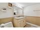Well-lit bathroom features a granite countertop vanity and paneled wall accents at 854 Village Way, Palm Harbor, FL 34683