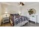 Bedroom with hardwood floors, ceiling fan, and decorative mirror and dresser at 854 Village Way, Palm Harbor, FL 34683