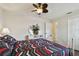 Cozy bedroom with a decorative mirror, ceiling fan, and stylish bedding at 854 Village Way, Palm Harbor, FL 34683