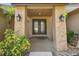Inviting front entrance with double doors, decorative plants, and outdoor lanterns at 854 Village Way, Palm Harbor, FL 34683