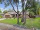 Charming single-story home featuring a well-manicured lawn, and a two-car garage at 854 Village Way, Palm Harbor, FL 34683