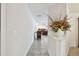 Inviting hallway leading to a cozy living area with a fireplace, filled with natural light at 854 Village Way, Palm Harbor, FL 34683