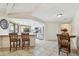 Open kitchen and dining area features granite countertops, white cabinets, and stainless steel appliances at 854 Village Way, Palm Harbor, FL 34683
