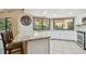 Kitchen featuring granite countertops, white cabinets, stainless steel appliances and a breakfast bar with seating at 854 Village Way, Palm Harbor, FL 34683