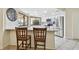Modern kitchen with stainless steel appliances, a granite countertop, and a breakfast bar with chairs at 854 Village Way, Palm Harbor, FL 34683