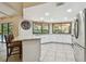 Bright kitchen with stainless steel appliances, white cabinets, and a breakfast bar overlooking the pool at 854 Village Way, Palm Harbor, FL 34683