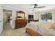 Spacious main bedroom has a view of the pool, with lanai access at 854 Village Way, Palm Harbor, FL 34683