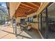 Screened in patio with outdoor bar seating and lounge chairs next to a swimming pool at 854 Village Way, Palm Harbor, FL 34683