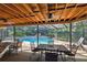 Enclosed pool with stone waterfall feature, outdoor seating, and tongue and groove wood roof at 854 Village Way, Palm Harbor, FL 34683