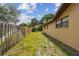 Side yard featuring a well maintained lawn and a privacy fence offers an outdoor space at 854 Village Way, Palm Harbor, FL 34683