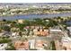 Wonderful aerial neighborhood view of housing developments with a beautiful river in the background and tennis courts at 904 Villa Venicia Way, Tampa, FL 33606