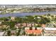 Scenic aerial view of waterfront property showcasing the city's waterways, lush greenery, and neighborhood layout at 904 Villa Venicia Way, Tampa, FL 33606