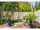 Cozy backyard patio area with lush tropical landscaping and string lights at 904 Villa Venicia Way, Tampa, FL 33606