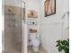 Bathroom featuring a glass-enclosed shower, toilet and white wood paneling at 904 Villa Venicia Way, Tampa, FL 33606