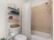 Practical bathroom featuring a toilet, bathtub, shower, and a handy storage shelf at 904 Villa Venicia Way, Tampa, FL 33606