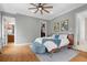 Bedroom with wood floors, a ceiling fan, and ample natural light at 904 Villa Venicia Way, Tampa, FL 33606