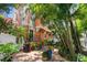 Townhome exterior with lush tropical landscaping and a private patio space at 904 Villa Venicia Way, Tampa, FL 33606