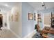 Spacious hallway leading to an office, decorated with photos and wood floors at 904 Villa Venicia Way, Tampa, FL 33606