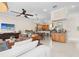 A spacious and inviting living room featuring an open layout with a cozy sitting area and an adjacent kitchen at 904 Villa Venicia Way, Tampa, FL 33606
