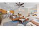 Spacious open-concept living room and kitchen area with a ceiling fan, modern furnishings, and natural light at 904 Villa Venicia Way, Tampa, FL 33606