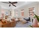 Living room with neutral paint, ceiling fan, many windows and comfortable seating at 904 Villa Venicia Way, Tampa, FL 33606