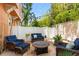 Outdoor patio with wicker furniture, a fire pit, and views of the surrounding greenery at 904 Villa Venicia Way, Tampa, FL 33606