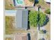 Overhead view of a single-Gathering home with a gray roof, long driveway, and fenced in yard at 906 Hacienda Dr, Sun City Center, FL 33573