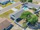 Aerial view of a home with an inground pool, fenced yard, and mature trees at 906 Hacienda Dr, Sun City Center, FL 33573