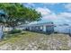 Large backyard with mature tree providing ample shade and fenced for privacy at 906 Hacienda Dr, Sun City Center, FL 33573