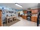 Spacious eat-in kitchen with wood cabinets, tile floors, and open layout at 906 Hacienda Dr, Sun City Center, FL 33573