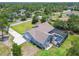 Overhead view of home featuring screened-in pool, long driveway, and attached two-car garage at 9091 Mazette Rd, Weeki Wachee, FL 34613