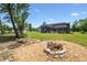Picturesque backyard featuring a fire pit and a screened-in pool, ideal for outdoor gatherings at 9091 Mazette Rd, Weeki Wachee, FL 34613