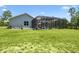 Spacious backyard with a screened-in pool and lush green lawn, perfect for outdoor activities at 9091 Mazette Rd, Weeki Wachee, FL 34613