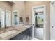 Bathroom vanity with granite countertops and wood cabinets, leading to a bright bedroom at 9091 Mazette Rd, Weeki Wachee, FL 34613