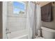 Bright white bathroom with a tub-shower combination and a window that brings in natural light at 9091 Mazette Rd, Weeki Wachee, FL 34613